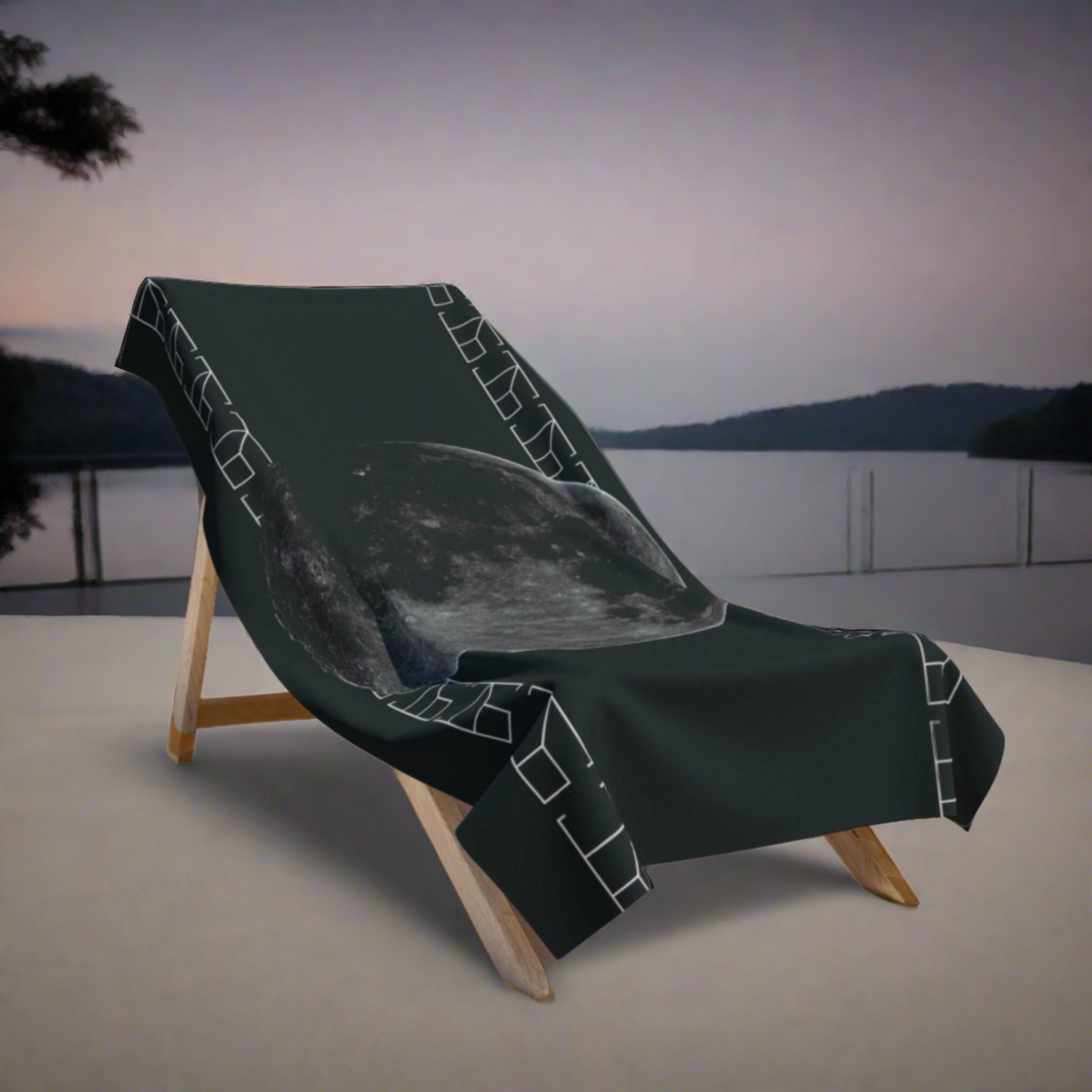 A secluded observation deck under the open night sky creates the perfect backdrop for the Nocturnal Silence Collection bath towel, which lies on a wooden deckchair. The dark silhouette of the surrounding forest contrasts with the starlit heavens, reflecting the towel's astral elegance and offering a sense of tranquil solitude